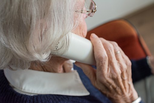 woman phoning helping elderly relatives around the house 